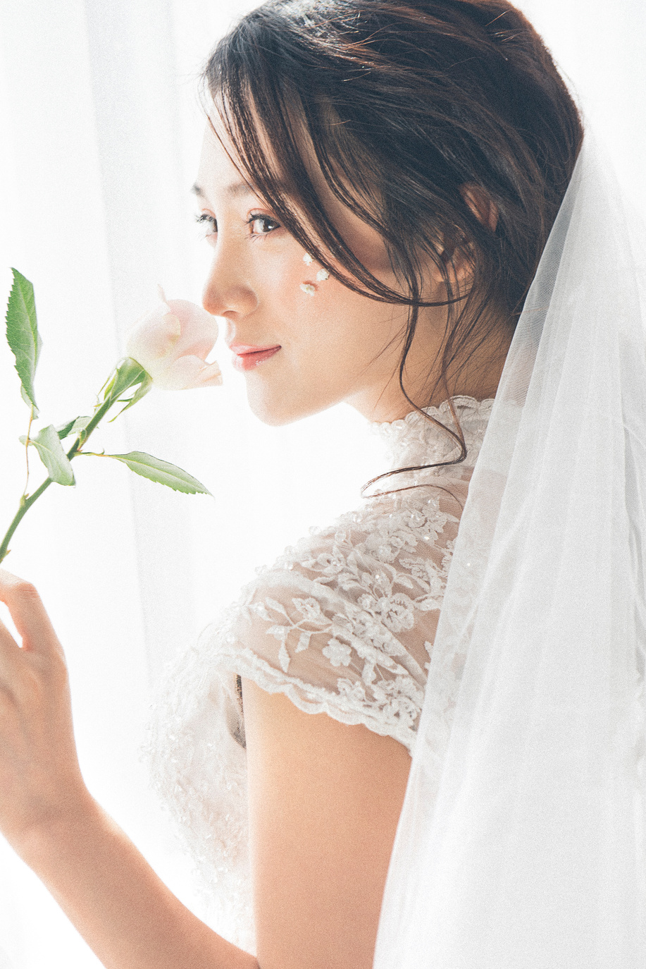 Woman Wearing White Lace Encrusted Wedding Gown and Veil