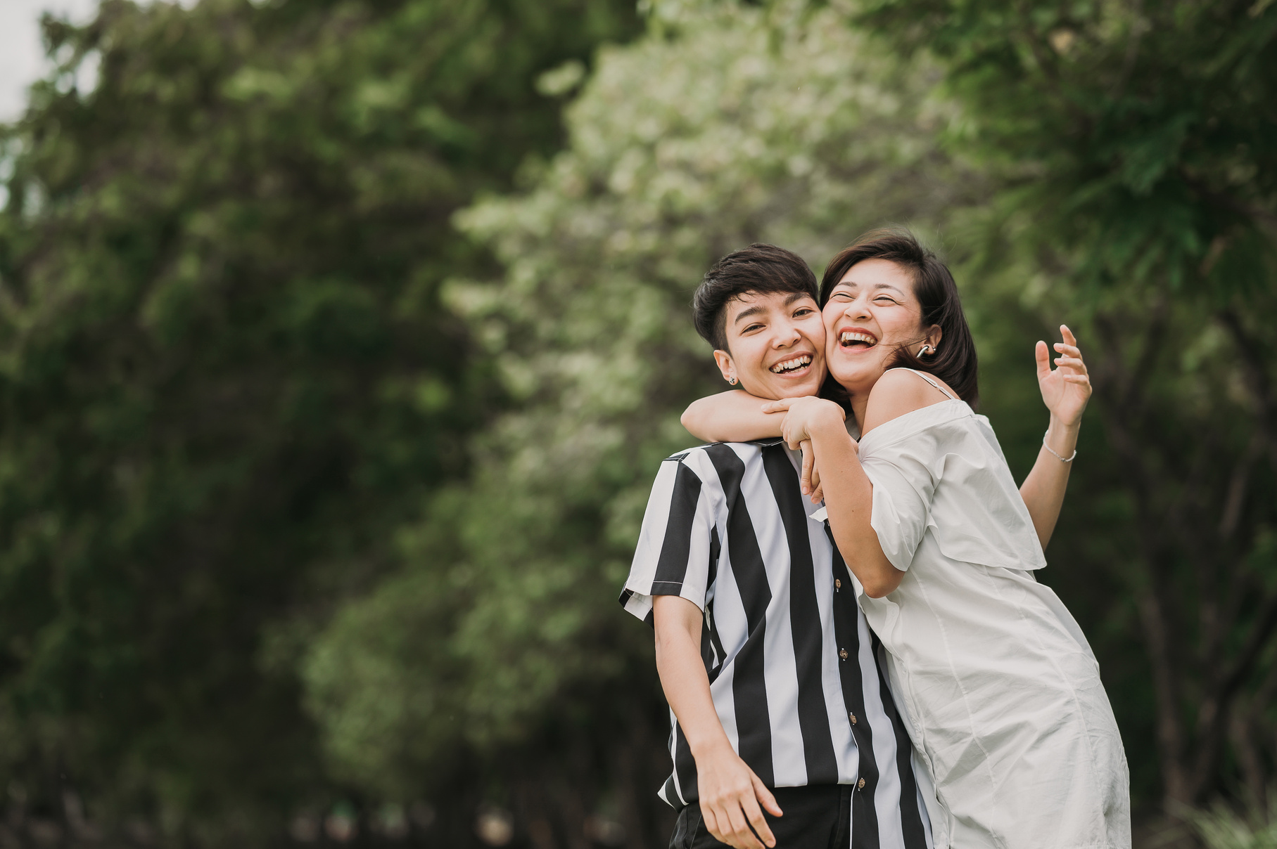 Happy Lesbian Couple Embracing Each Other Outdoors