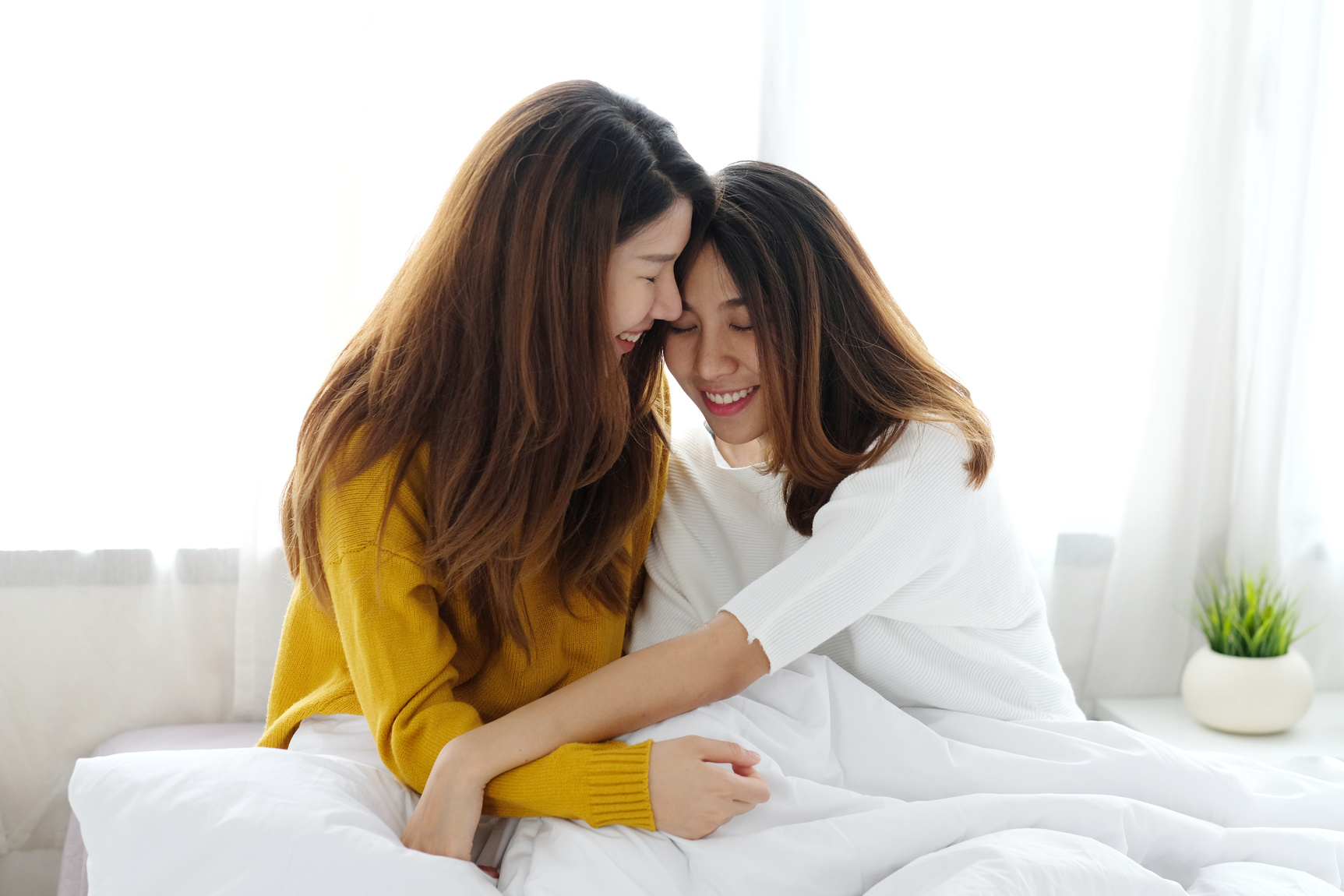 Lesbian Couple Cuddling Indoors