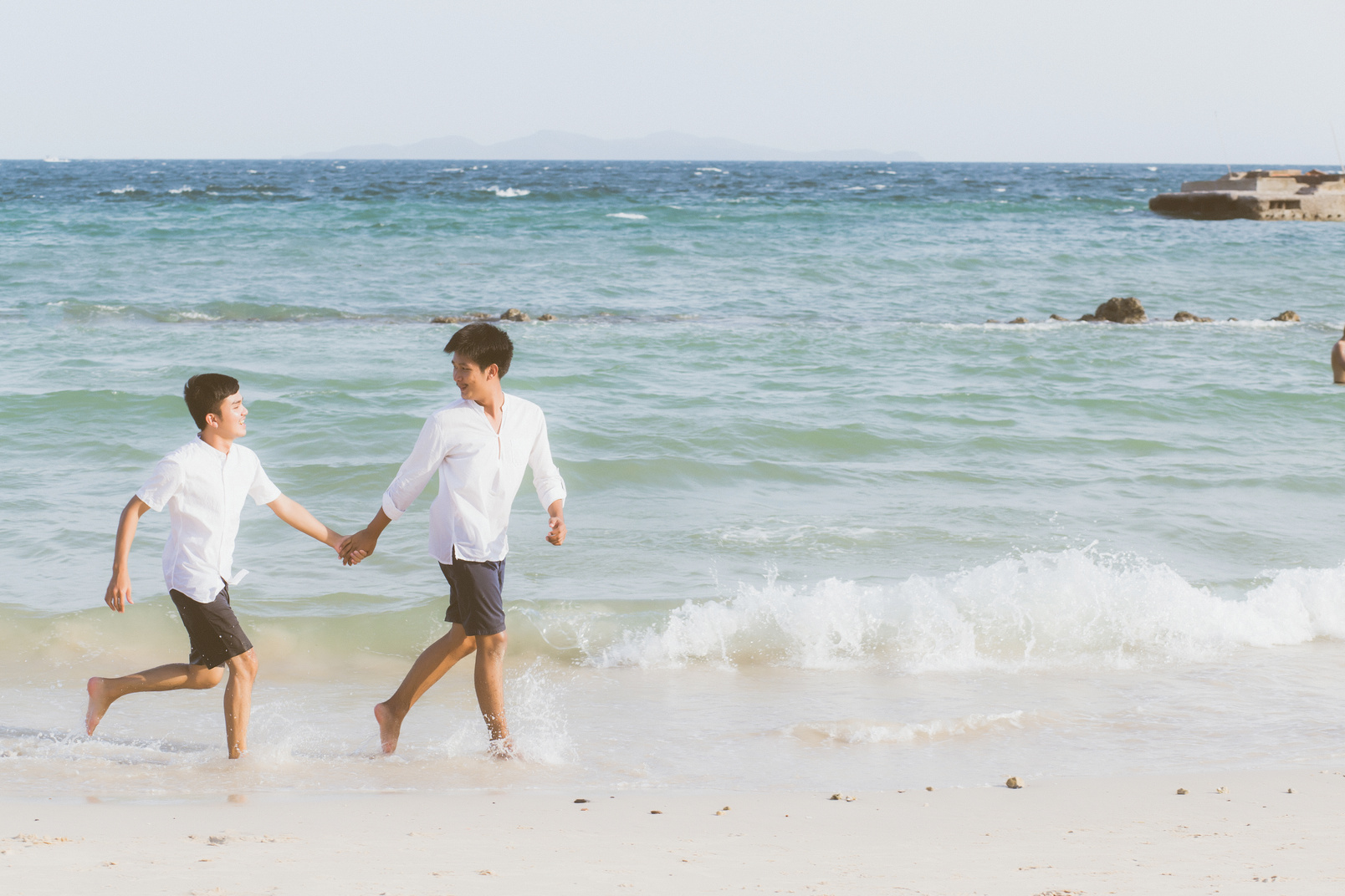 Asian Gay Couple Running at the Beach 