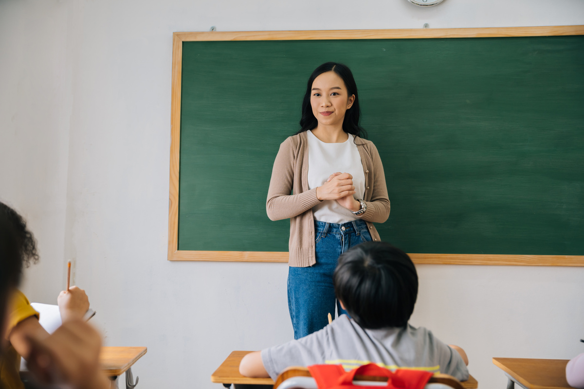 Asian School Teacher Speaking on Her Class